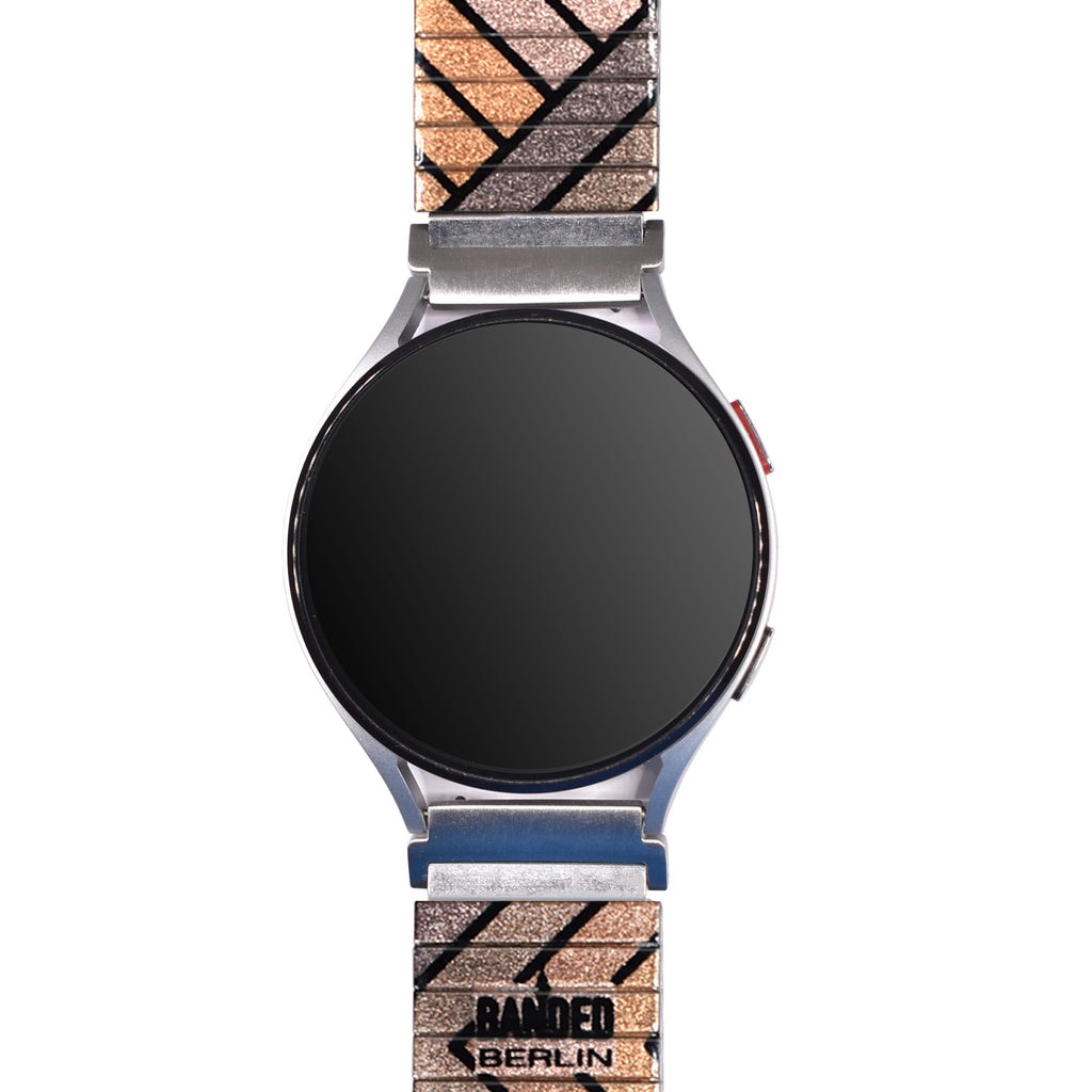 Metropolis - Babylon - Banded™ Smart Watch - Metallic Finish  Babylon - Die 20er Jahre sind das Jahrzehnt der Lichtspielhäuser. Überall kann man für ein paar Pfennige dem Alltag in der Großstadt entfliehen. Träum auch du Dich in filmreife Welten.
