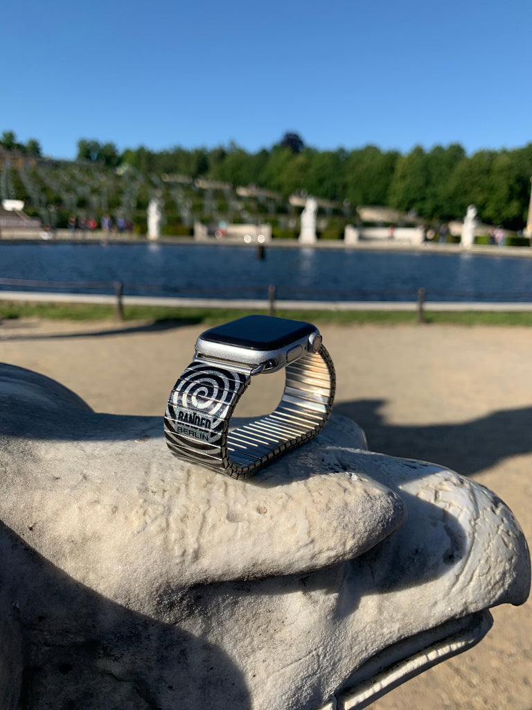 Twilight Zone Banded™ Smart Watch  Was gibt es Schöneres, als eine visuelle Ablenkung, während man angespannt darauf warted im Flugzeug upgegraded zu werden? Mit diesem funkelnd-hypnotischen Style schlägst Du jeden in Deinen Bann.